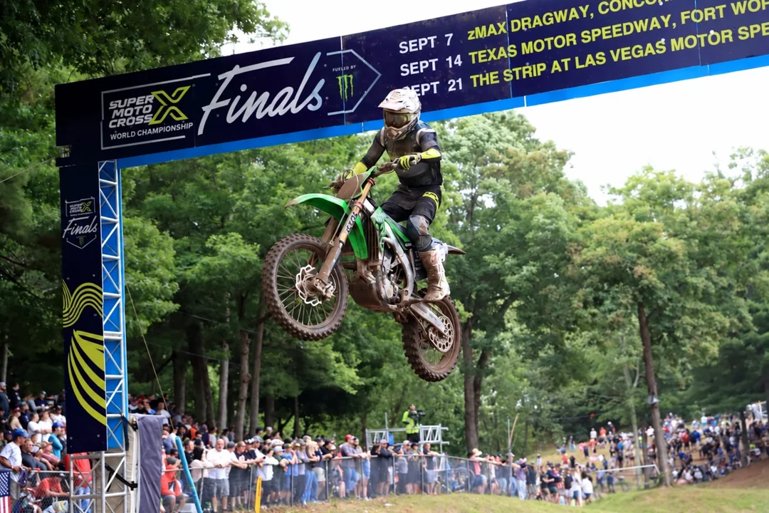 Geran Stapleton competing on his green motocross bike