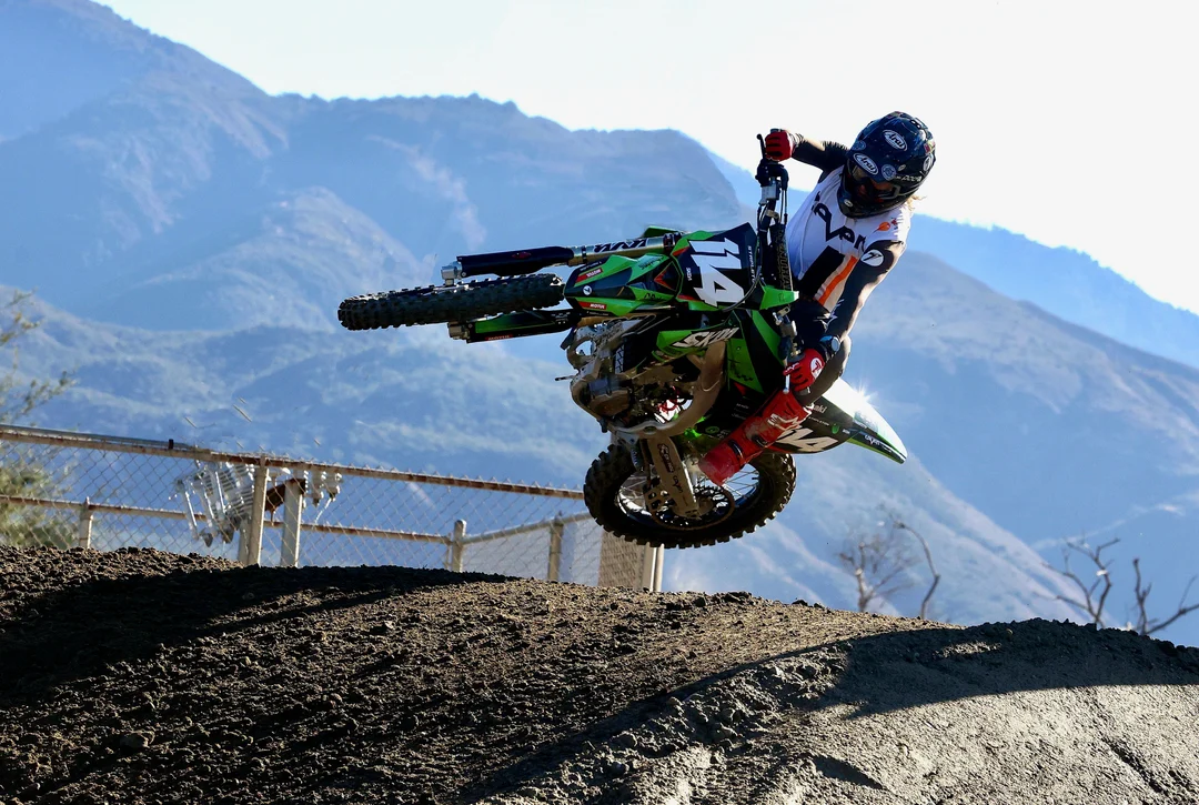 Geran Stapleton riding a green motocross bike in California